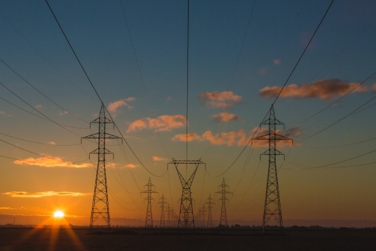 Three rows of electricity pylons