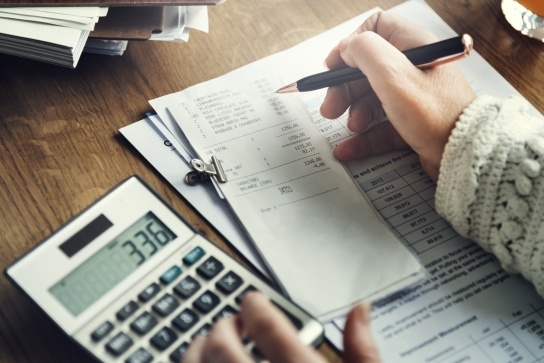 Person checking tax on bill